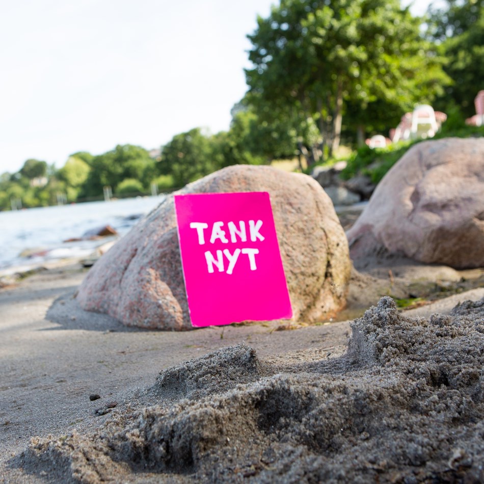 Tænk nyt-skilt ved en søbred